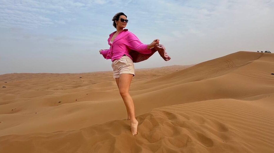 Helen Waldorf standing alone in the desert during a peaceful holiday moment